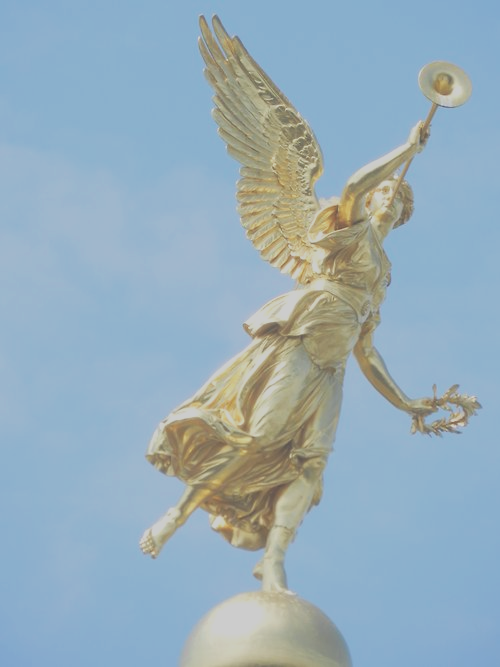 A golden statue of an angel blowing a horn.